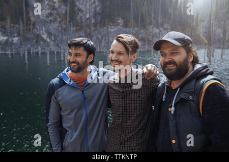 Three friends having fun at Kaindy lake, Kazakhstan Stock Photo