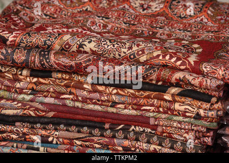 Stack of shawls at a market stall, Dilli Haat, New Delhi, India Stock Photo