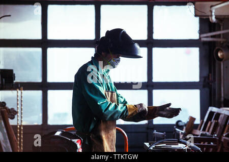 Man wearing protective workwear in workshop Stock Photo