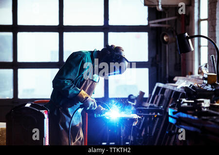 Worker welding in workshop Stock Photo