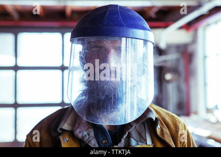 Portrait of worker in protective mask in factory Stock Photo