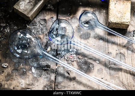 Overhead view of manufactured glasses on work bench at factory Stock Photo