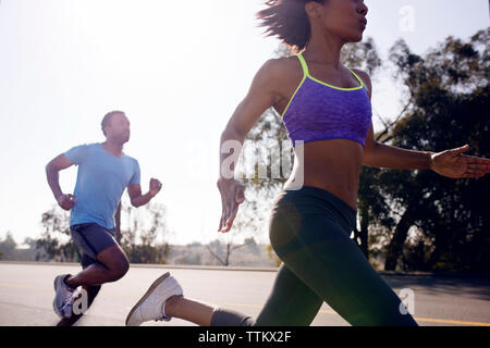 Couple jogging on street Stock Photo