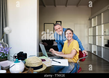 Portrait of happy senior couple planning vacation at home Stock Photo