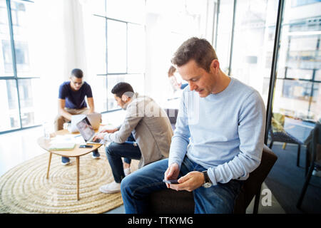Male colleagues working in room at office Stock Photo
