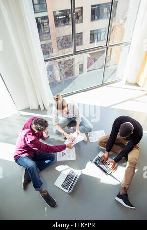 High angle view of business people working by window in office Stock Photo
