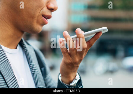 Midsection of businessman talking on smart phone Stock Photo