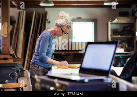 Female worker standing in workshop Stock Photo