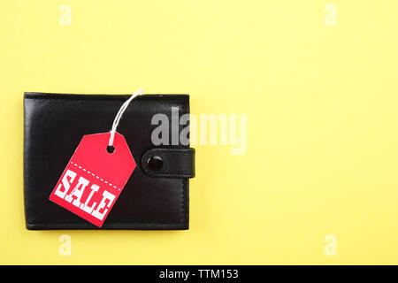 Wallet with sale tag on yellow background Stock Photo