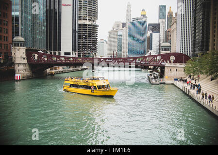 Yellow water taxi sailing on Chicago River in city Stock Photo