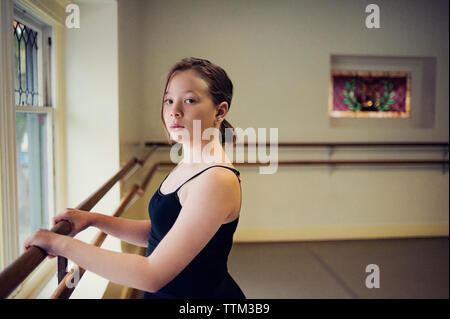 Portrait of ballet dancer standing at dance studio Stock Photo