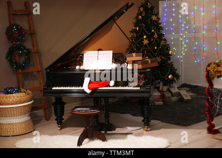 Santa hat on piano keys with Christmas decorations Stock Photo