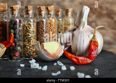 Assorted dry spices in glass bottles, close up Stock Photo