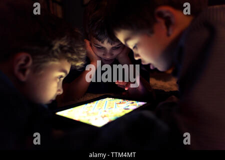 Siblings playing game on tablet computer at home Stock Photo