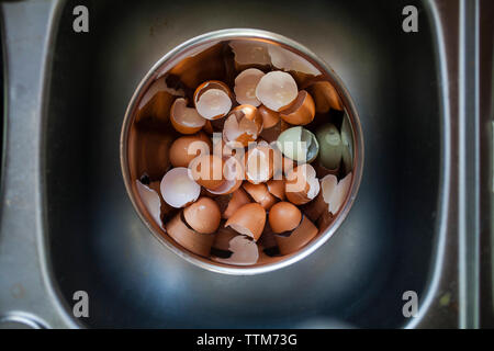Overhead view of eggshells in bowl at kitchen Stock Photo
