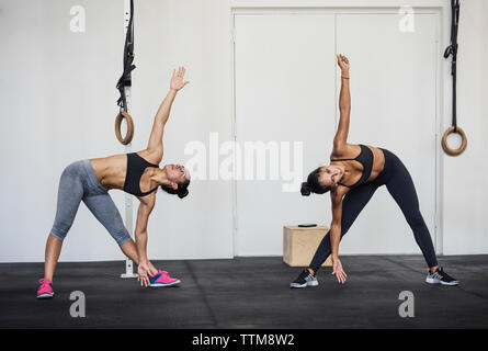 Female athletes doing warm up exercises in crossfit gym Stock Photo