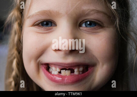 Close-up portrait of happy girl showing teeth Stock Photo