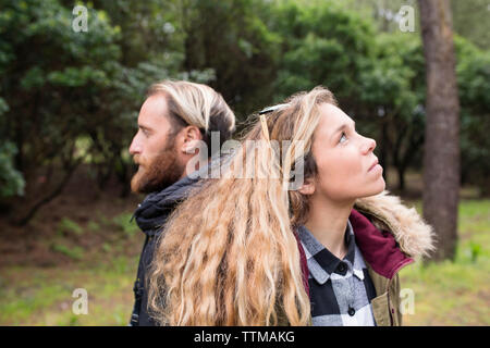 Thoughtful couple in forest Stock Photo