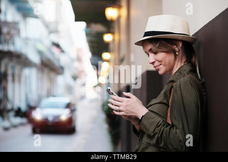 Young Woman Vacationing in Panama waits for Uber car in Casco Antiguo Stock Photo