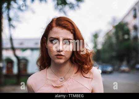 Portrait of young cute redhead woman with freckles Stock Photo