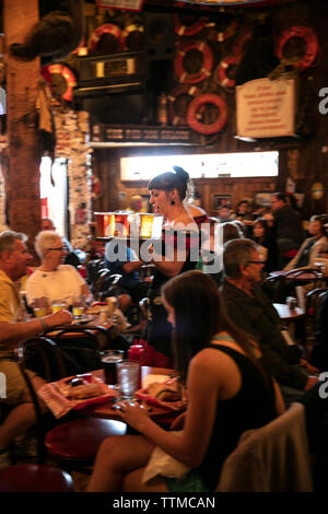 USA, Alaska, Juneau, individuals gather and dine inside of the Red Dog Saloon in downtown Juneau Stock Photo