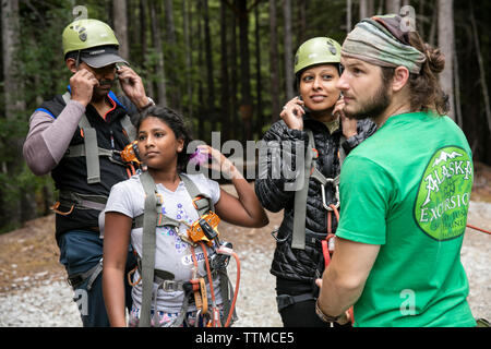 USA Alaska, Sitka, participants prepare for their 4-hour adventure where they will zip past massive spruce, cedars and glacially fed waterfalls, Grizz Stock Photo