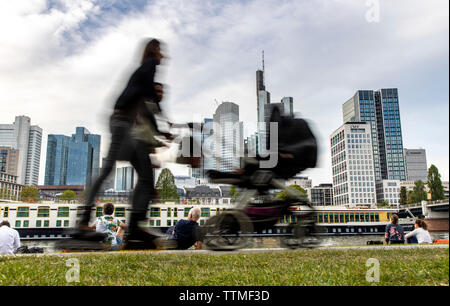 Frankfurt am Main, view of the skyline of the city center, from the left bank of the Main, river side walk, Stock Photo