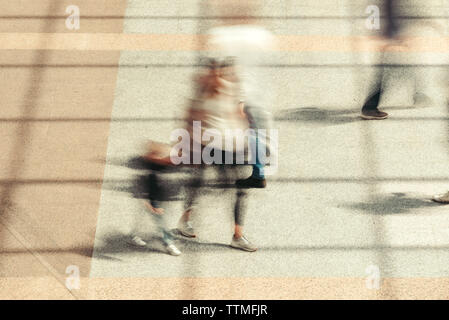 Group of people, motion blur effect. Unrecognizable commuters walking during rush hour.