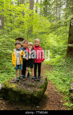 USA, Oregon, Santiam River, Brown Cannon, young boys pose for a photo in the Willamete National Forest before going out fishing