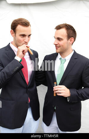 USA, Tennessee, Nashville, Iroquois Steeplechase, twin brothers enjoy their cigars Stock Photo