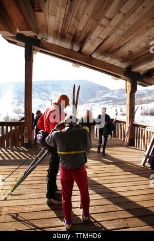 USA, Utah, Midway, Soldier Hollow, men prepare to go for a Nordic cross country ski Stock Photo