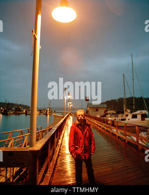 Fishing boat skipper checks the GPS receiver on a fishing boat in the  Pacific Ocean off the coast of Westport, Washington, USA Stock Photo - Alamy