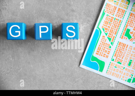 Cubes with word GPS and map on grey background, top view Stock Photo