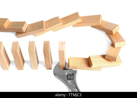 Dominoes with wrench, isolated on white Stock Photo
