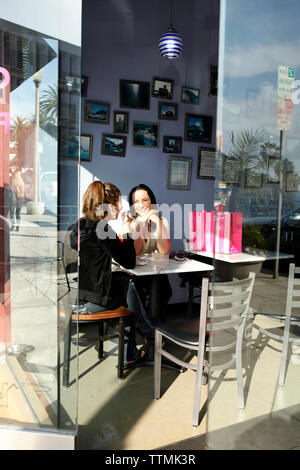 USA, California, San Diego, two women chat over gelato at Frizzante Gelateria Stock Photo