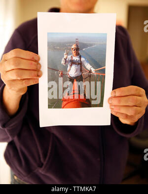 USA, California, San Francisco, Marie Curie holds a photo of a bridge worker who died in a car accident Stock Photo