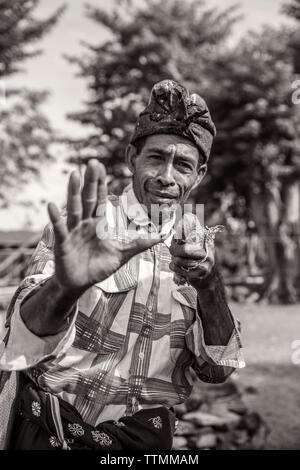INDONESIA, Flores, a man demonstrates one of his traditional boxing poses in his village Kampung Tutubhada in Rendu Stock Photo