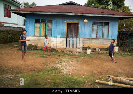 INDONESIA, Flores, kids play soccer in front of their home in Ruteng Stock Photo