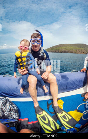 GALAPAGOS ISLANDS, ECUADOR, individuals getting ready to go snorkeling in the waters near Tagus Cove Stock Photo