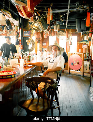 USA, Florida, fishing boat captain sitting at bar, Aj's Seafood Restaurant, Destin Stock Photo