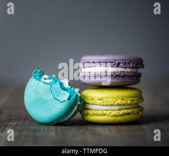 Close-up of colorful macaroons on wooden table Stock Photo