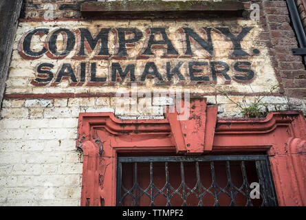 An abandoned sailmaker stores warehouse with original sign and door. Stock Photo