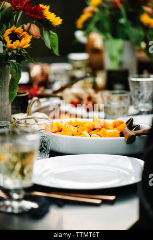 Pumpkin served in plate with wine on table Stock Photo