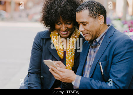 Happy couple using mobile phone Stock Photo