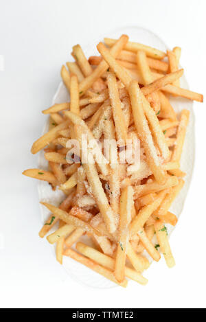 Overhead view of French fries in plate on white background Stock Photo