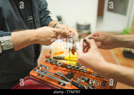 Cropped image of man with coworker at workshop Stock Photo