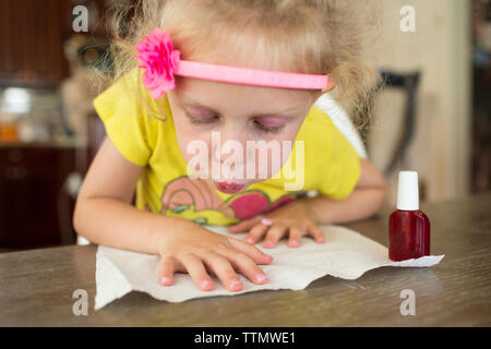 Girl painting fingernails at home Stock Photo