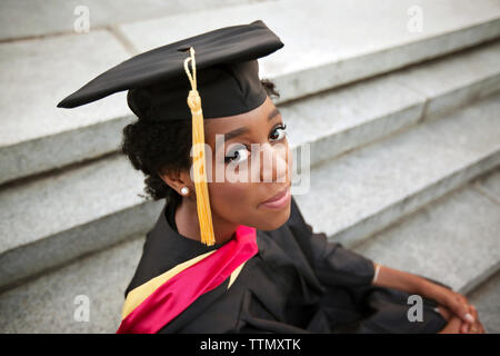 Portrait of woman wearing graduation gown Stock Photo