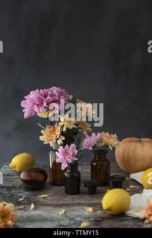 Pink and orange flowers on vintage vases Stock Photo