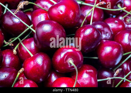 ripe, juicy red cherries on a white background on a plate Stock Photo